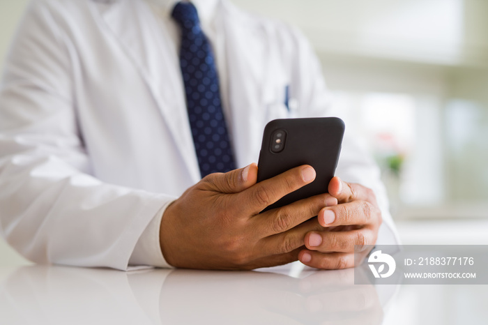 Close up middle age doctor man hands using smartphone