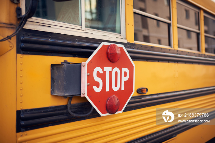 Side view of a school bus and its stop signal