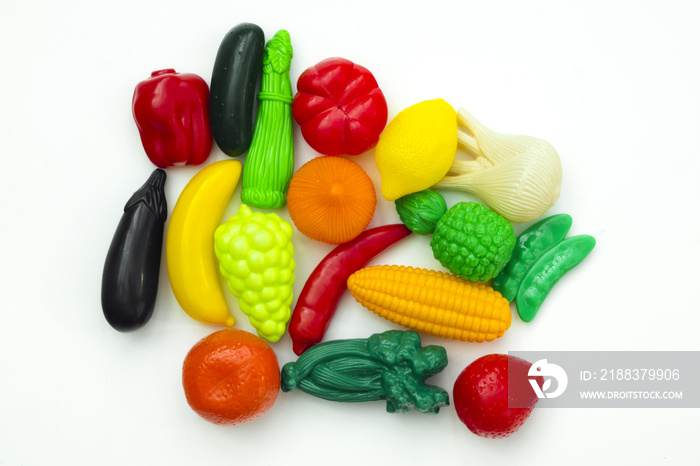 Group of vegetable and fruit plastic toys for children in isolated white background