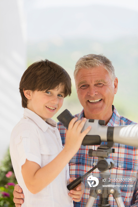 Portrait happy grandfather and grandson using telescope