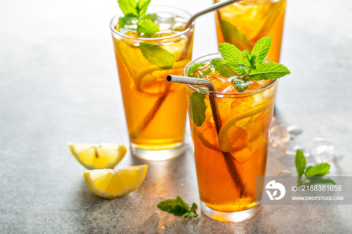 Iced tea with lemon and mint, cold and refreshing summer drink with ice