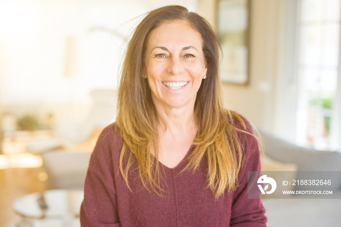 Beautiful middle age woman smiling at home