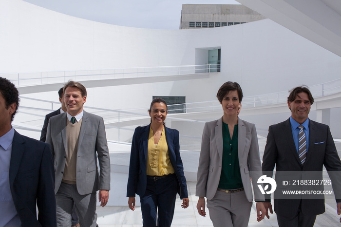 Corporate business people walking in modern courtyard