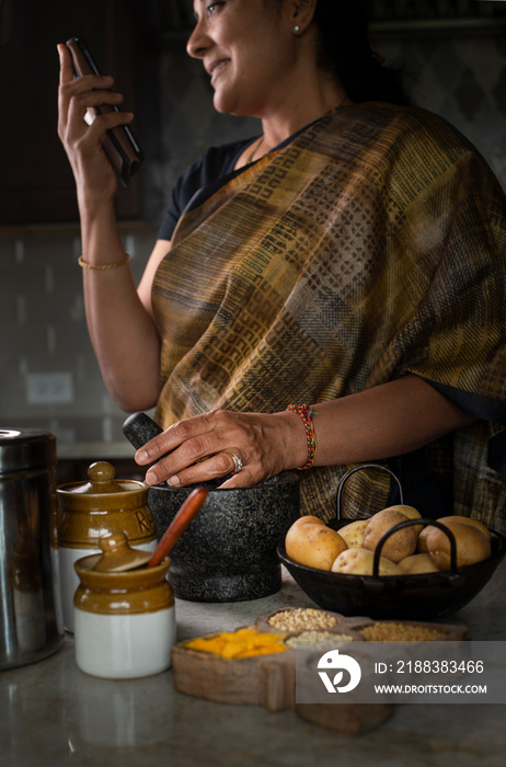 Woman in sari cooking in the kitchen