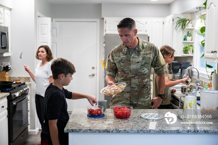 Air Force service member has breakfast with his family before leaving for work.