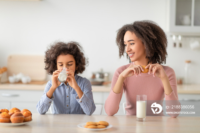 Little Black Girl And Afro Woman Drinking Milk