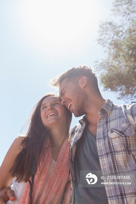 Happy young couple hugging in sunshine