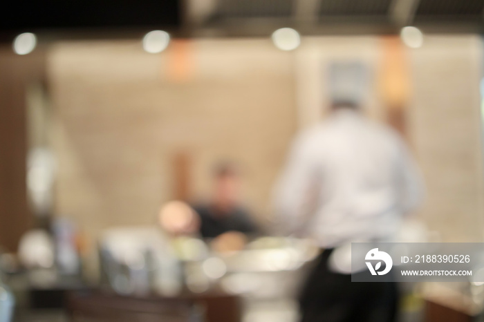 Chef cooking in restaurant kitchen abstract blurred defocused background