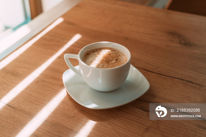 First coffee in the morning, coffee cup on the table with copy space