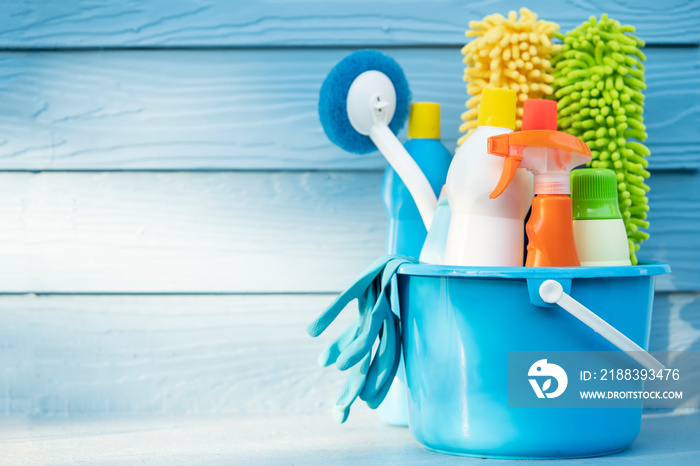 House cleaning product on wood table with blue background