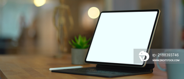 Mock up digital tablet on wooden table in blurred background