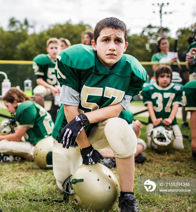 Boys posing in field before American football match