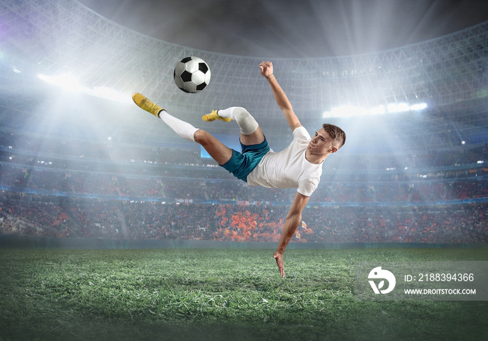 Soccer player on a football field in dynamic action at summer day under sky with clouds. Sporty man 