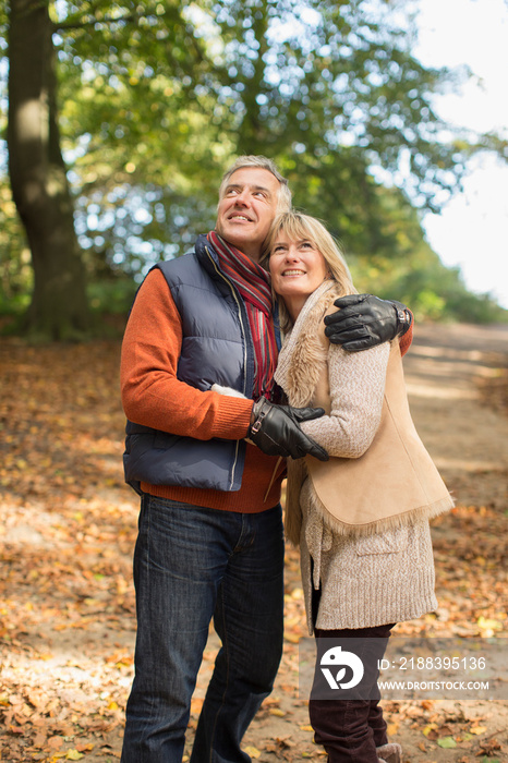 Happy mature couple hugging in autumn park