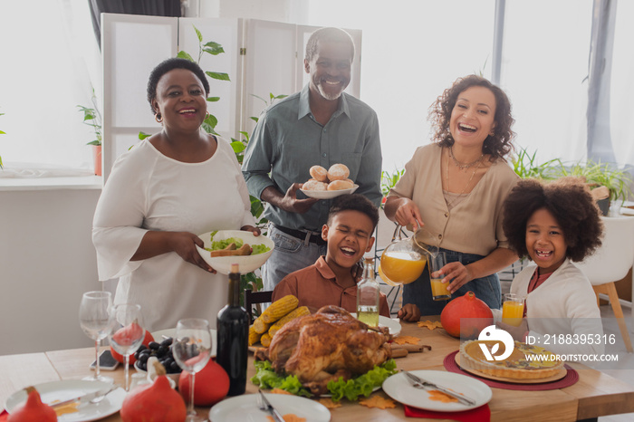 Cheerful african american family celebrating thanksgiving near food at home