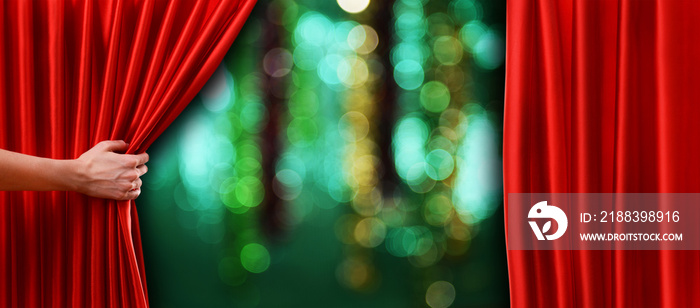 Red curtain on theater or cinema stage slightly open