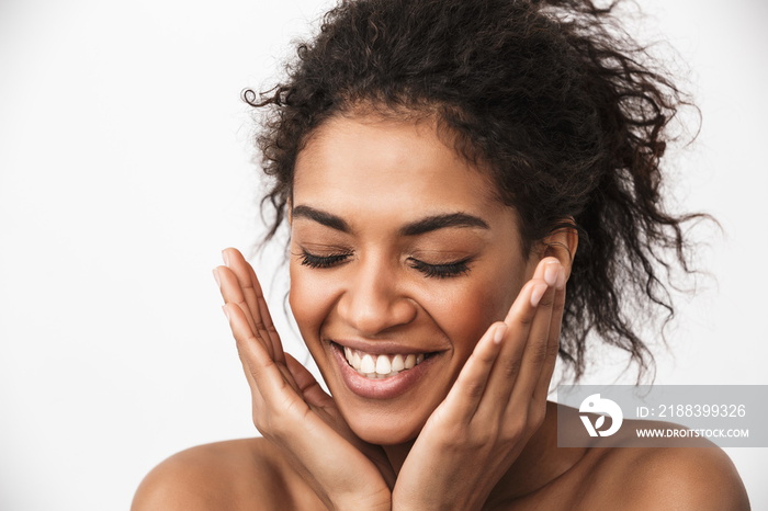 Happy young african woman posing isolated over white wall background.