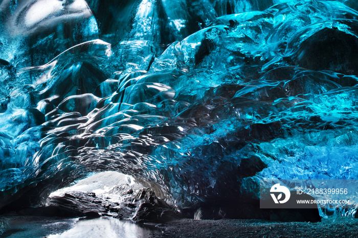 Blue crystal ice cave and an underground river beneath the glacier. Amazing nature of Skaftafell, Ic