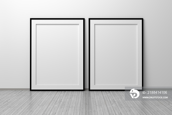 Mockup template of two vertical A4 frame with thin black frame border standing next to wall on woode