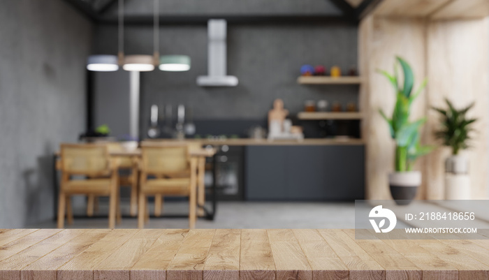 Wood table top on blur kitchen counter.