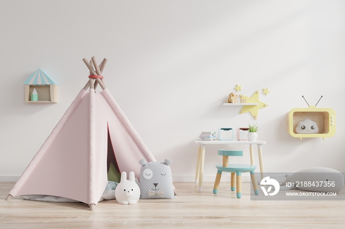 Childrens playroom with tent and table sitting behind the white wall.