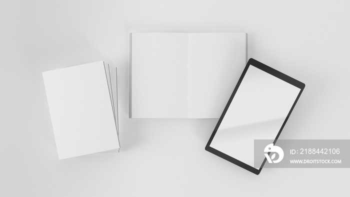 Top view of open and closed books with tablet