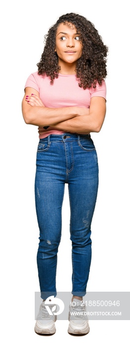 Young beautiful woman with curly hair wearing pink t-shirt smiling looking side and staring away thinking.