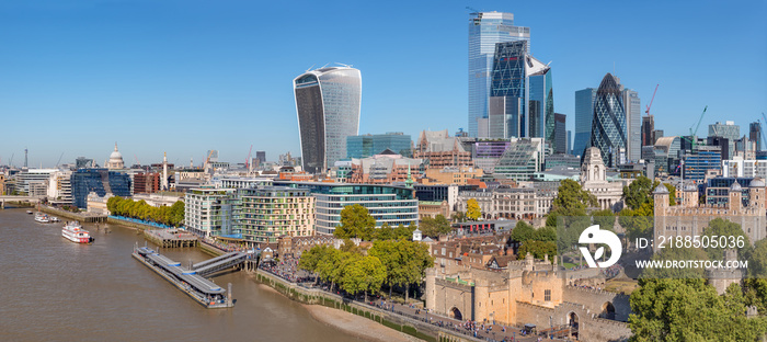 Aerial cityscape of the Thames river on a sunny day with the City Financial district skyscrapers and Tower of London.