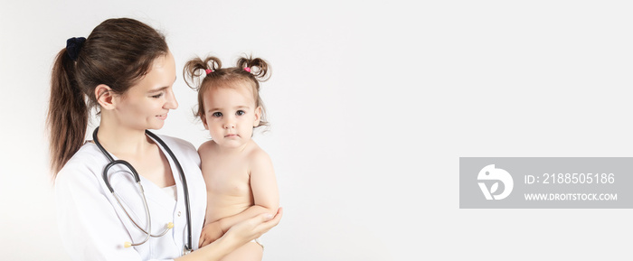 female doctor with happy one year old baby girl. copy space. Banner