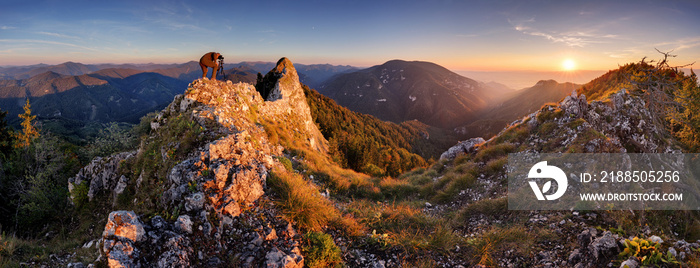 Mountain autumn panorama at sunset with forest and rocks.