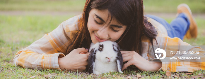 relationships of cheerful rabbit and happy young human girl, domestic friendship family of little cute easter pet and friends person having smile and fun, animal love and care at home concept