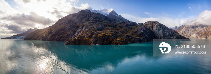 Beautiful Panoramic View of American Mountain Landscape on the Ocean Coast during a cloudy and colorful morning in fall season. Taken in Glacier Bay National Park and Preserve, Alaska, USA.