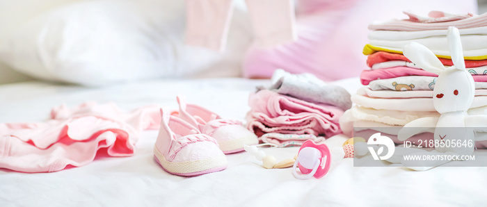 A pregnant woman is folding baby things. Selective focus.