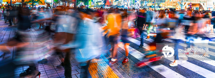 People and traffic cross the famous scramble intersection in Shibuya, Tokyo, Japan, one of the busiest crosswalks in the world