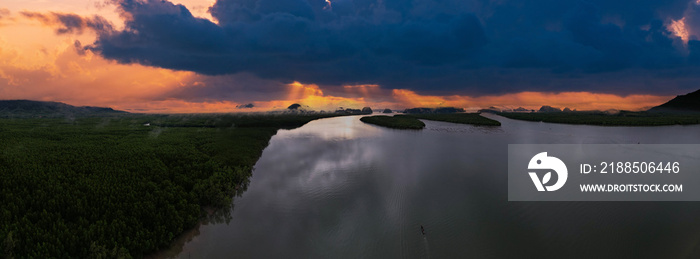 Panorama mountains view with sunset over sea surface water background,Amazing sea sun reflections,Aerial view over mountains view,Amazing sunrise light in dramatic sky