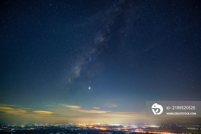 Panorama view universe space shot of milky way galaxy with stars on night sky background at mountains and city light landscape Thailand