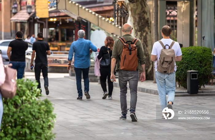 travelers in bags walking