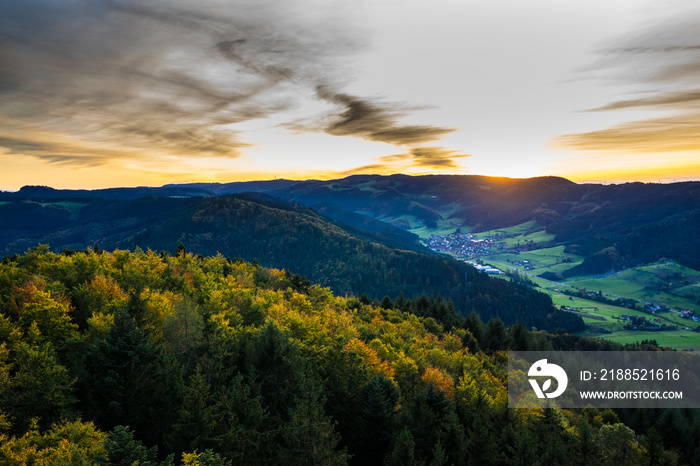 Germany, Endless aerial view above wide beautiful black forest vacation nature landscape above tree tops at sunset in autumn season