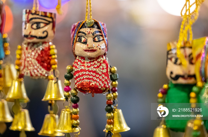 Handmade colorful Puppets or kathputli hanging with blur background. Selective focus on puppet.