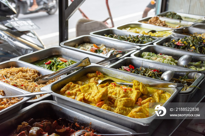 Indonesian food buffet dishes consist of meat, chicken, seafood and vegetables at Javanese restaurant in Bali.