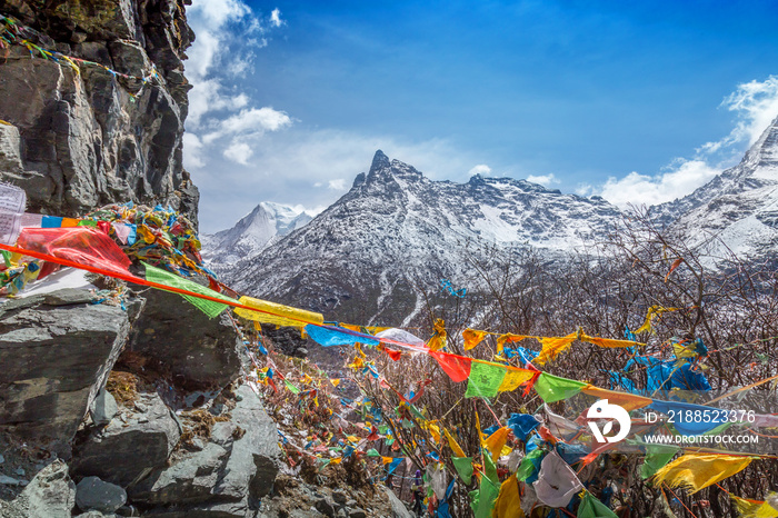 The Buddhist tibetan prayer flags on the top of mountain