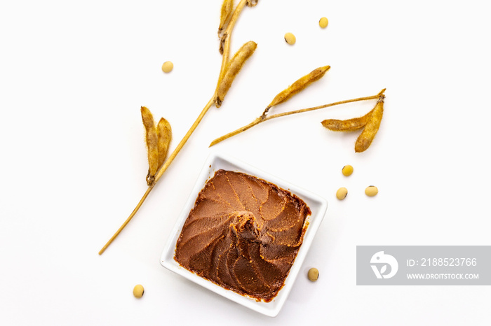 Light brown miso paste isolated on white background. Traditional Japanese seasoning, dry soya beans pods