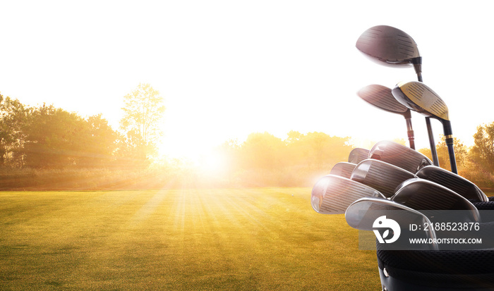 Golf clubs drivers  over beautiful golf course at the sunset, sunrise time. , morning time