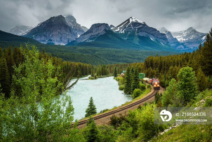 Train passing through Morant’s Curve in bow valley, Banff National Park, Canada