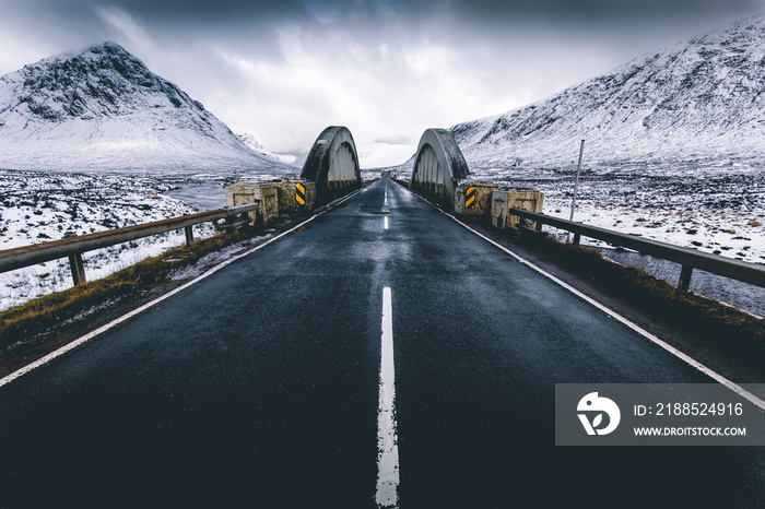 Open road winter snow mountain landscape in Glencoe Scotland