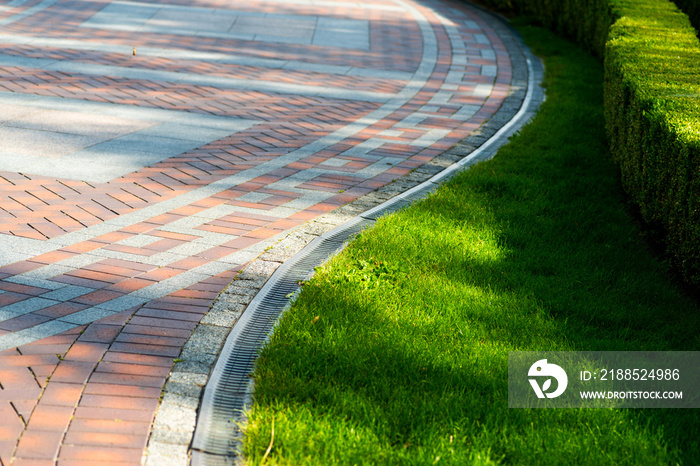 Pavement tile with drainage and shorn grass in landscape design