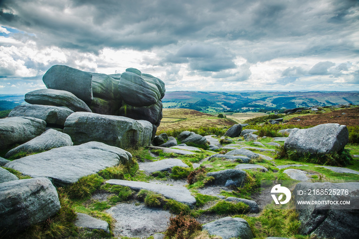 Hill walking on the gritstone outcrops on Higger Tor in the De rbyshire Peak Distrct