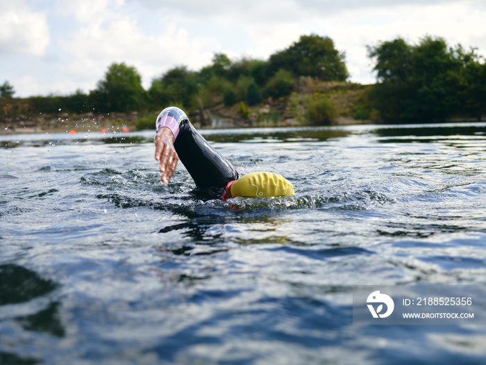 Woman in swimming cap swimming in river