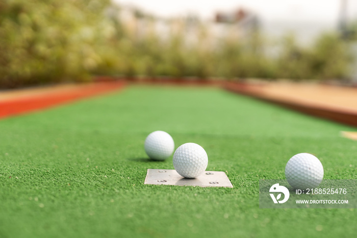 Mini-golf ball on artificial grass. Summer season game