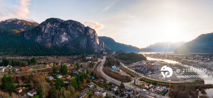 Aerial Panoramic View of Sea to Sky Highway, Residential Homes and Chief Mountain in the background. Colorful Sunset Sky. Taken in Squamish, North of Vancouver, British Columbia, Canada.